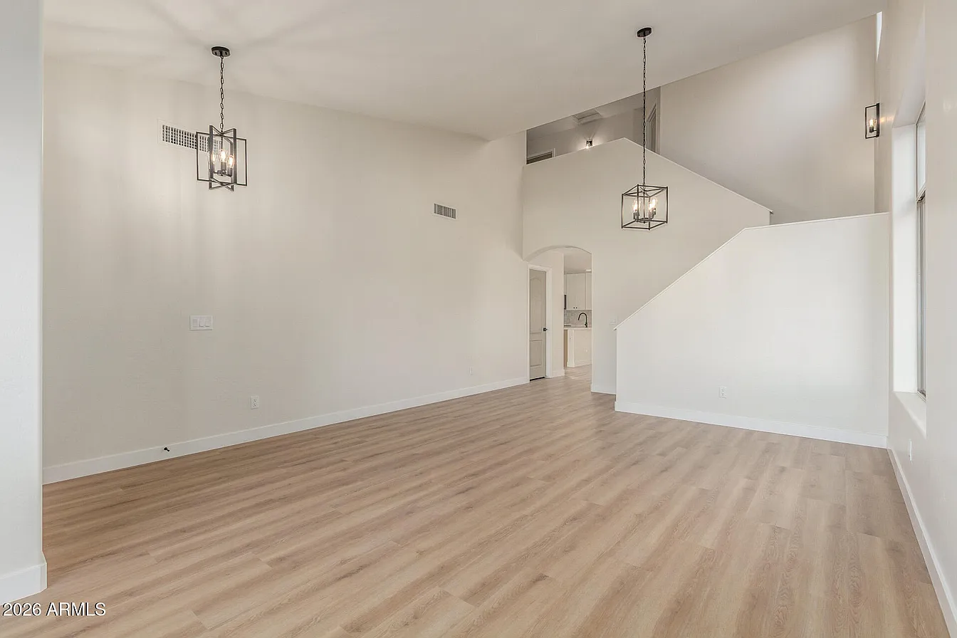 Open living and dining area with pendant lights and luxury vinyl plank flooring