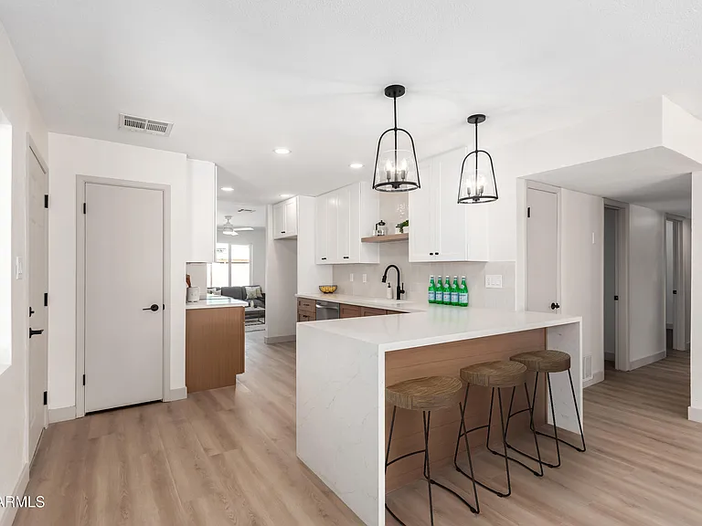 White and wood kitchen with waterfall island